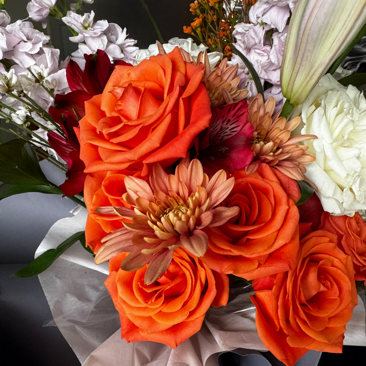 Amber Bliss – Orange Rose & Lilac Lily Bouquet
